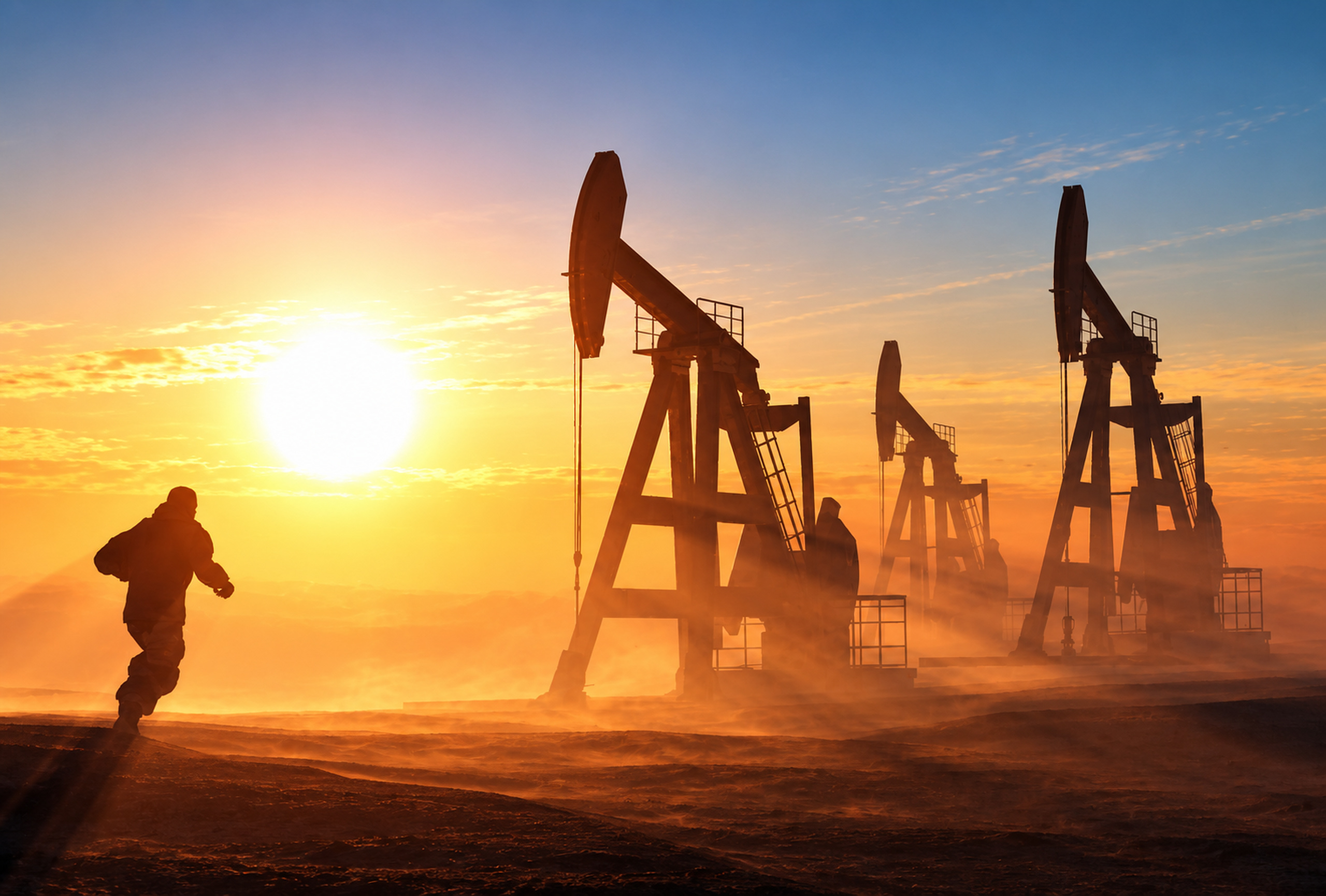 Oil pumpjacks working at sunrise